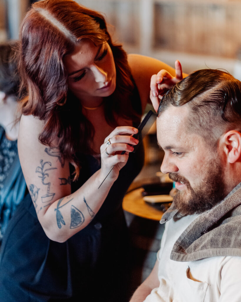 Female styling male's hair. 