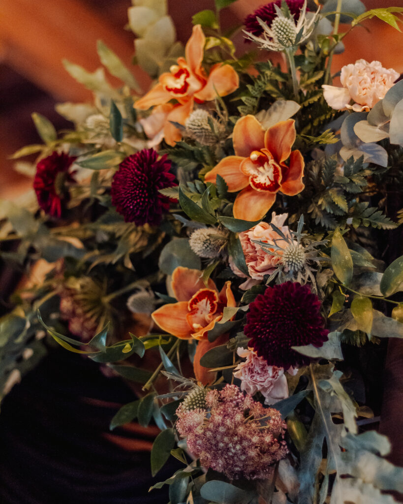 Orange and burgundy floral piece. 