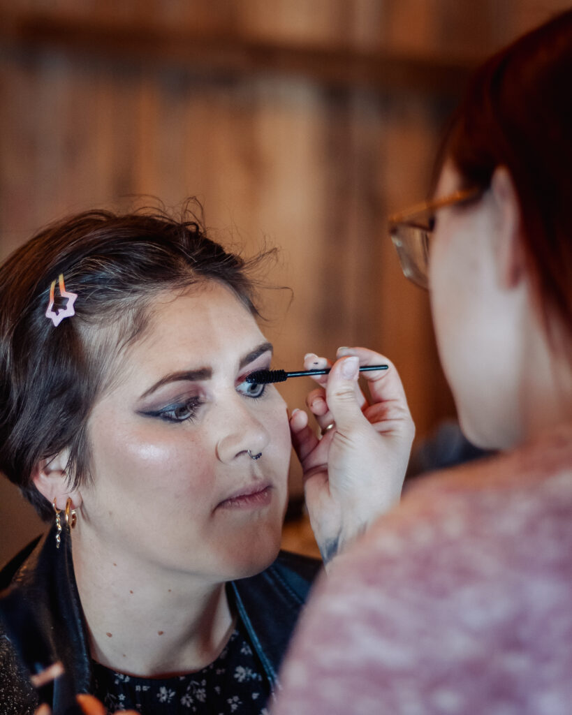 Makeup artist applying mascara. 